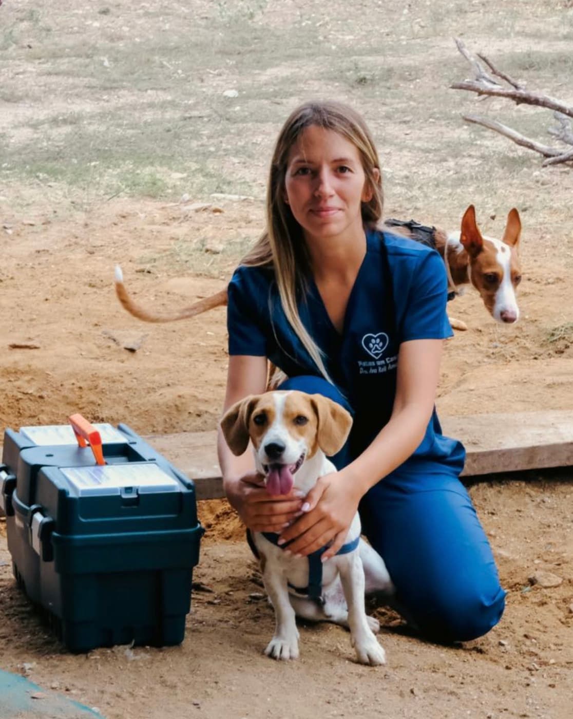 Dr. Ana Keil Amaral on a home visit, with two dogs
